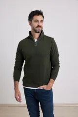 Sweater verde oscuro de tejido elastizado de algodón y poliéster, con medio cierre en el cuello, detalles de tela de algodón al tono y tirador de eco cuero.
