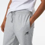 Pantalón de jogging New Balance gris melange, con cintura elástica ajustable con cordón, bolsillos laterales y logo estampado en la pierna izquierda.