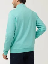 Buzo con cierre color verde agua, de algodón pima, con cuello alto, mangas largas y bolsillos internos.