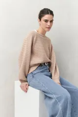 Sweater negro tramado de silueta relajada, con combinación de texturas en el tejido y mangas abullonadas con puños elastizados.