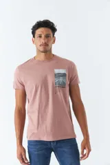 Remera color rosa con estampado rectangular en el frente que contiene una fotografía de un camino y la frase "KEEP MOVING FORWARD".