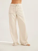 Pantalón negro de tiro medio alto, corte palazzo, con bolsillos delanteros y traseros.