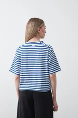 Remera de manga corta con cuello a la base, confeccionada en tejido de rayas horizontales blancas y negras, con silueta relajada.