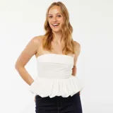 Corpiño strapless blanco con efecto globo en el ruedo.