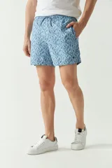 Short de baño celeste con estampado de hojas, cintura elástica con cordón ajustable, dos bolsillos laterales y uno trasero.