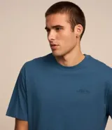 Remera relaxed de algodón color azul con estampa lettering y dibujo de una linterna en la espalda.
