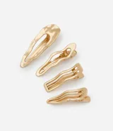 Set de cuatro pinzas para el pelo doradas con diferentes diseños ondulados.