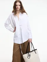 Camisa blanca de algodón con cuello camisero y cierre frontal con botones.
