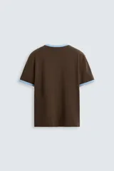 Camiseta azul marino de corte regular, con cuello redondo y mangas cortas. Presenta rib a contraste en cuello y mangas.