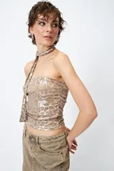 Top strapless color beige con estampado animal print metalizado y pañuelo a tono que se ata al cuello.