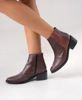 Botas cortas de cuero vacuno color marrón con estampado de piel de serpiente, taco de madera foliado en cuero y cierre lateral con cremallera.
