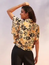 Camisa de corte suelto con estampado floral en tonos amarillos y negros.