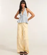 Blusa peplum con escote halter y lazo en el frente, con patrón de rayas verticales azules y blancas.