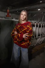 Sweater de lana tejido y bordado a mano en Uruguay, de calce holgado con cuello a la base y puños. Diseño con rombos en tonos rojo, negro, amarillo y marrón.