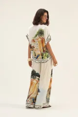 Pantalón palazzo de seda color crema con estampado de paisaje.
