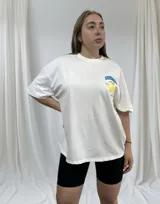 Remerón blanco de corte holgado con estampado de limones y texto en azul.
