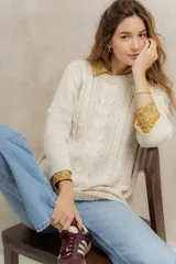 Sweater tejido en hilo de algodón color crudo, con cuello redondo, corte holgado, hombros caídos y diseño de ochos en la parte delantera.