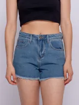 Short de jean con terminación desflecada, cinco bolsillos y cierre metálico.