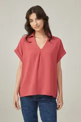 Blusa color salmón de viscosa, corte holgado, con cuello camisero y mangas cortas con dobladillo.