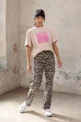 Remera blanca de algodón con estampa rectangular en tonos beige y texto negro.