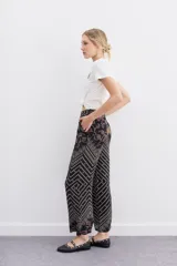 Pantalón palazzo de tiro alto confeccionado en viscosa estampada. Presenta cierre lateral invisible y bolsillos diagonales.
