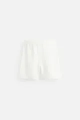 Bermuda negra regular fit confeccionada en tejido de algodón con estructura. Cintura elástica ajustable con cordón, bolsillos laterales y bolsillo trasero de vivo.
