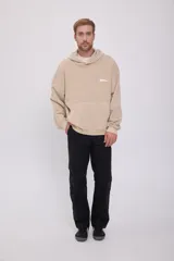 Hoodie color beige con estampado en la espalda con la frase "Originals Studio dept" en letras blancas.