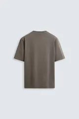 Camiseta blanca de algodón de peso medio, corte recto, cuello redondo y mangas cortas.