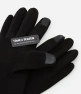 Guantes grises de poliéster y poliuretano, con detalle touch screen en uno de los dedos.