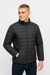 Campera negra de nylon con cierre frontal y cuello alto. Diseño acolchado con bolsillos laterales y puños elásticos.