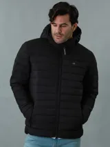 Campera acolchada negra con capucha, cierre frontal con cremallera y bolsillos laterales con cremallera. Logo de Calvin Klein en el pecho.