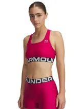 Top deportivo Under Armour HeatGear® Armour Mid Crossback, color fucsia, con logo blanco en el frente y banda elástica con la inscripción "Under Armour".