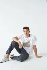 Pantalón cargo color marrón claro, de gabardina, con corte regular, bolsillos laterales y logo bordado.