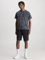 Remera gris con estampado abstracto en negro y logo de Calvin Klein en el pecho.