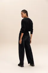 Pantalón de plush negro, de corte recto con cintura media y bolsillos delanteros y trasero.