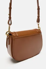 Bolso bandolera color marrón con solapa y correa ancha de tela color crudo.