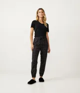 Pantalón de pijama de franela de la marca Lov, color negro con estampado de cuadros blancos y rosados. Cuenta con cintura elástica, cordón ajustable y elástico en el bajo.
