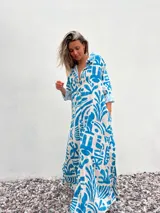 Vestido camisero largo de corte amplio, con estampado abstracto en tonos celeste y crudo.