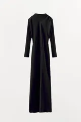 Vestido largo negro de tejido satinado, con cuello subido, manga larga y drapeado en los hombros. Presenta una abertura en la espalda con cierre de botones forrados a tono.