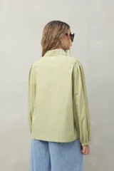 Camisa blanca de mangas 3/4 abullonadas con bordado floral en el frente.