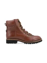 Botín alpino de cuero color marrón con detalles metálicos, cordones de algodón y base de goma estilo trucker con pespuntes en contraste.
