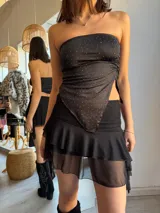 Top strapless negro con estampado de lunares blancos y corte irregular.