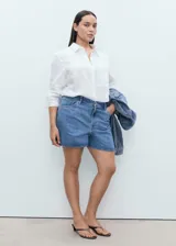 Short de jean celeste de tiro alto, con cinco bolsillos y cierre frontal con cremallera y botón.