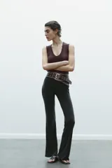 Camiseta negra de corte ajustado (slim fit) con escote pico pronunciado y manga sisa.