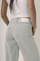 Pantalón de denim tiro alto, corte wide leg, color azul medio con estampado de pequeños lunares blancos.