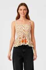 Musculosa de bretel fino con estampado multicolor, corte al cuerpo con punto smock y elástico, escote profundo y reguladores en los breteles.