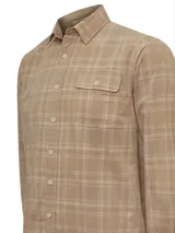 Camisa de franela de algodón orgánico a cuadros en tonos azul, gris y verde. Tiene cuello camisero, manga larga, un bolsillo en el pecho y cierre con botones.