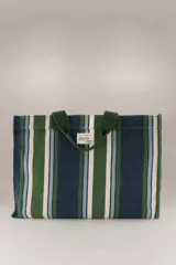 Bolso tote de algodón a rayas verticales en tonos azul marino, verde, celeste y blanco. Tiene doble asa de mano en color verde oscuro, bolsillo interior grande, bolsillo para teléfono y bolsillo para llaves.