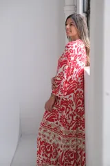 Vestido largo color rojo con estampado floral blanco y beige, corte amplio y mangas 3/4.