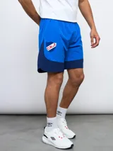 Short de entrenamiento azul marino y azul eléctrico, con escudo del Club Nacional de Football estampado en el lateral.